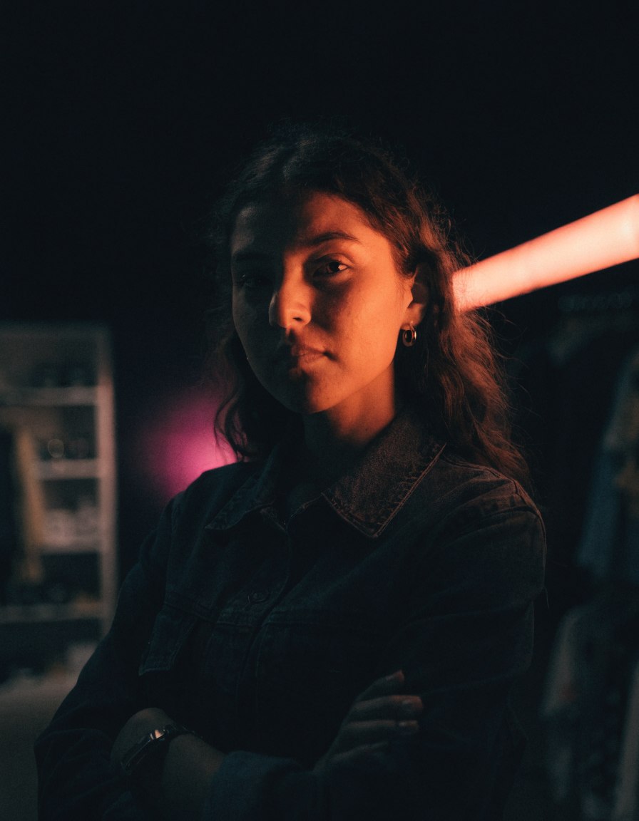 Emprendedora mexicana en su negocio, iluminada por luz coral